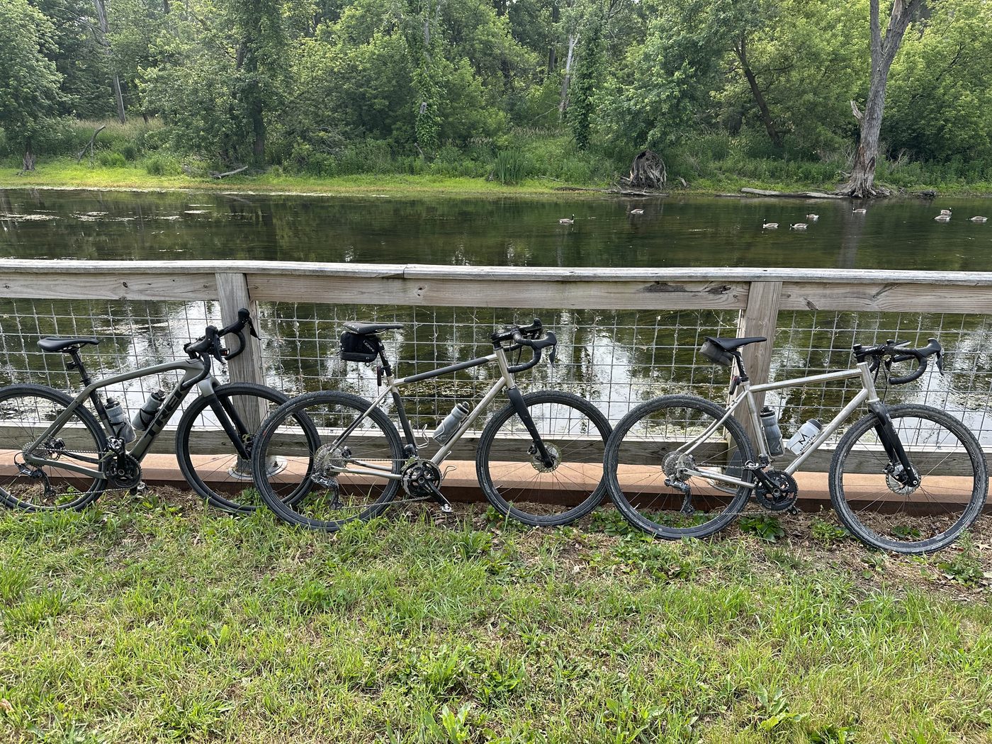 Three bikes lined up on the bridge